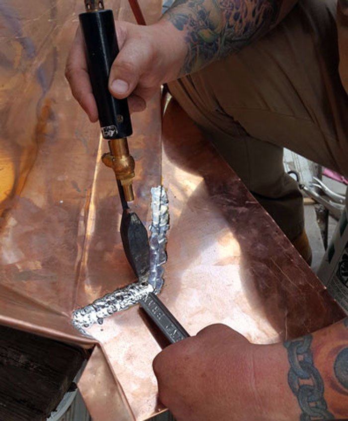 Solder copper flashings is taught at the Slate Roofing Contractors Association conference.